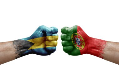 Two hands punch to each others on white background. Country flags painted fists, conflict crisis concept between bahamas and portugal