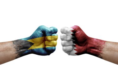 Two hands punch to each others on white background. Country flags painted fists, conflict crisis concept between bahamas and qatar