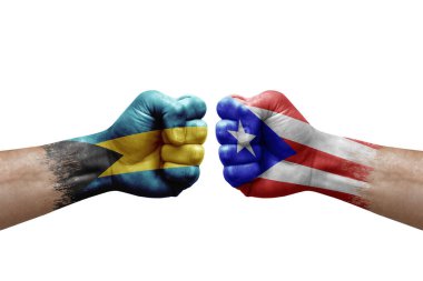 Two hands punch to each others on white background. Country flags painted fists, conflict crisis concept between bahamas and puerto rico