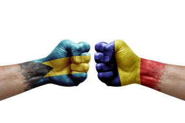 Two hands punch to each others on white background. Country flags painted fists, conflict crisis concept between bahamas and romania