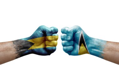 Two hands punch to each others on white background. Country flags painted fists, conflict crisis concept between bahamas and saint lucia