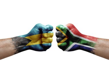 Two hands punch to each others on white background. Country flags painted fists, conflict crisis concept between bahamas and south africa