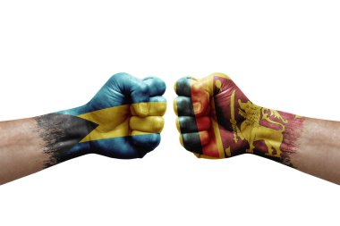 Two hands punch to each others on white background. Country flags painted fists, conflict crisis concept between bahamas and sri lanka