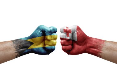 Two hands punch to each others on white background. Country flags painted fists, conflict crisis concept between bahamas and tonga