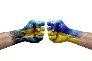 Two hands punch to each others on white background. Country flags painted fists, conflict crisis concept between bahamas and ukraine