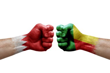 Two hands punch to each others on white background. Country flags painted fists, conflict crisis concept between bahrain and benin