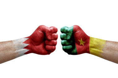 Two hands punch to each others on white background. Country flags painted fists, conflict crisis concept between bahrain and cameroon