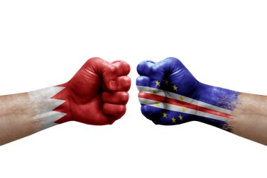 Two hands punch to each others on white background. Country flags painted fists, conflict crisis concept between bahrain and cape verde