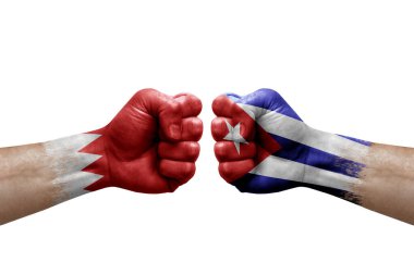 Two hands punch to each others on white background. Country flags painted fists, conflict crisis concept between bahrain and cuba