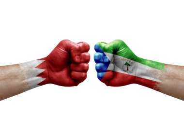 Two hands punch to each others on white background. Country flags painted fists, conflict crisis concept between bahrain and equatorial guinea