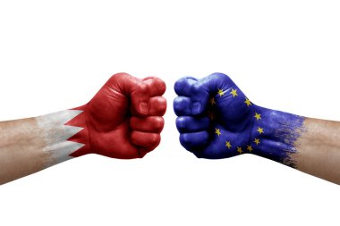 Two hands punch to each others on white background. Country flags painted fists, conflict crisis concept between bahrain and european union