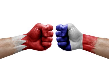 Two hands punch to each others on white background. Country flags painted fists, conflict crisis concept between bahrain and france