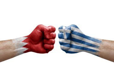 Two hands punch to each others on white background. Country flags painted fists, conflict crisis concept between bahrain and greece