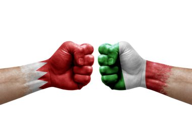 Two hands punch to each others on white background. Country flags painted fists, conflict crisis concept between bahrain and italy