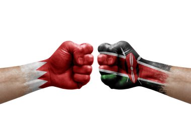 Two hands punch to each others on white background. Country flags painted fists, conflict crisis concept between bahrain and kenya