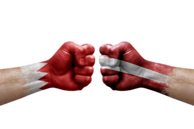 Two hands punch to each others on white background. Country flags painted fists, conflict crisis concept between bahrain and latvia