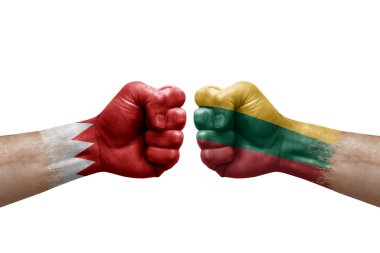Two hands punch to each others on white background. Country flags painted fists, conflict crisis concept between bahrain and lithuania