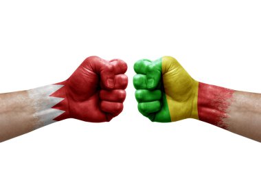 Two hands punch to each others on white background. Country flags painted fists, conflict crisis concept between bahrain and mali