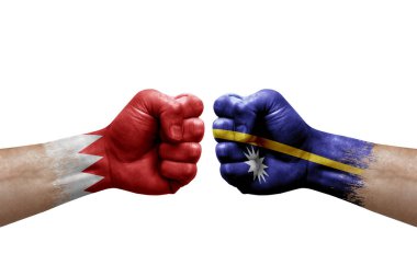 Two hands punch to each others on white background. Country flags painted fists, conflict crisis concept between bahrain and nauru