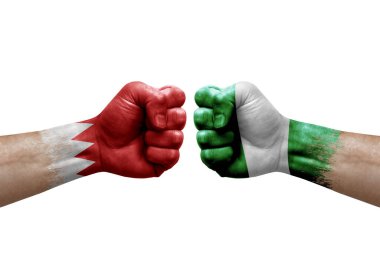 Two hands punch to each others on white background. Country flags painted fists, conflict crisis concept between bahrain and nigeria