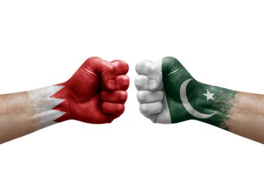 Two hands punch to each others on white background. Country flags painted fists, conflict crisis concept between bahrain and pakistan