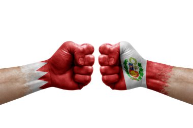 Two hands punch to each others on white background. Country flags painted fists, conflict crisis concept between bahrain and peru
