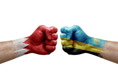Two hands punch to each others on white background. Country flags painted fists, conflict crisis concept between bahrain and rwanda