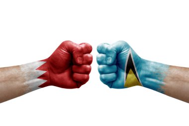 Two hands punch to each others on white background. Country flags painted fists, conflict crisis concept between bahrain and saint lucia