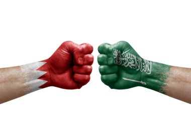 Two hands punch to each others on white background. Country flags painted fists, conflict crisis concept between bahrain and saudi arabia