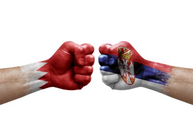 Two hands punch to each others on white background. Country flags painted fists, conflict crisis concept between bahrain and serbia