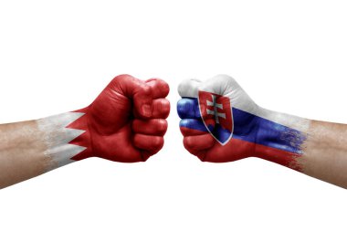Two hands punch to each others on white background. Country flags painted fists, conflict crisis concept between bahrain and slovakia