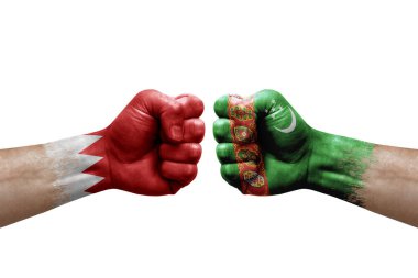 Two hands punch to each others on white background. Country flags painted fists, conflict crisis concept between bahrain and turkmenistan
