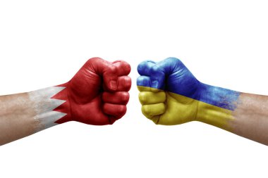 Two hands punch to each others on white background. Country flags painted fists, conflict crisis concept between bahrain and ukraine