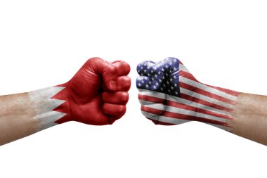 Two hands punch to each others on white background. Country flags painted fists, conflict crisis concept between bahrain and usa