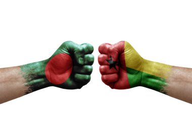 Two hands punch to each others on white background. Country flags painted fists, conflict crisis concept between bangladesh and guinea-bissau