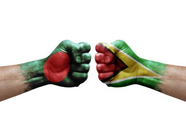 Two hands punch to each others on white background. Country flags painted fists, conflict crisis concept between bangladesh and guyana