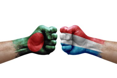 Two hands punch to each others on white background. Country flags painted fists, conflict crisis concept between bangladesh and luxembourg