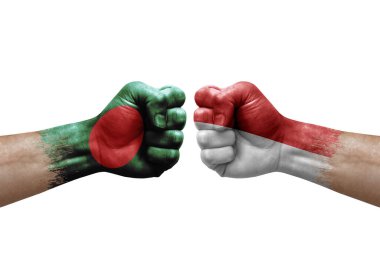 Two hands punch to each others on white background. Country flags painted fists, conflict crisis concept between bangladesh and monaco