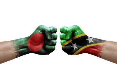 Two hands punch to each others on white background. Country flags painted fists, conflict crisis concept between bangladesh and saint kitts and nevis