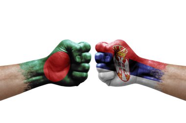 Two hands punch to each others on white background. Country flags painted fists, conflict crisis concept between bangladesh and serbia