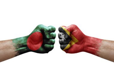 Two hands punch to each others on white background. Country flags painted fists, conflict crisis concept between bangladesh and timor leste