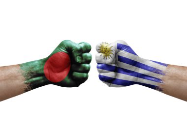 Two hands punch to each others on white background. Country flags painted fists, conflict crisis concept between bangladesh and uruguay