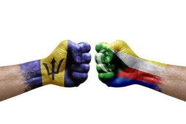 Two hands punch to each others on white background. Country flags painted fists, conflict crisis concept between barbados and comoros