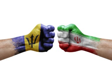 Two hands punch to each others on white background. Country flags painted fists, conflict crisis concept between barbados and iran