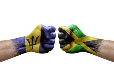 Two hands punch to each others on white background. Country flags painted fists, conflict crisis concept between barbados and jamaica