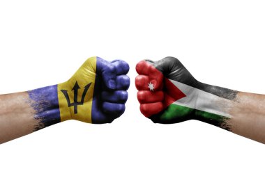 Two hands punch to each others on white background. Country flags painted fists, conflict crisis concept between barbados and jordan