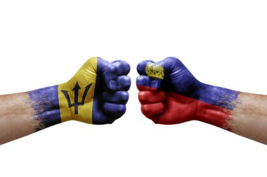 Two hands punch to each others on white background. Country flags painted fists, conflict crisis concept between barbados and liechtenstein
