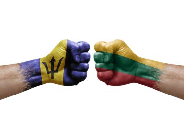 Two hands punch to each others on white background. Country flags painted fists, conflict crisis concept between barbados and lithuania