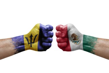Two hands punch to each others on white background. Country flags painted fists, conflict crisis concept between barbados and mexico