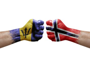 Two hands punch to each others on white background. Country flags painted fists, conflict crisis concept between barbados and norway